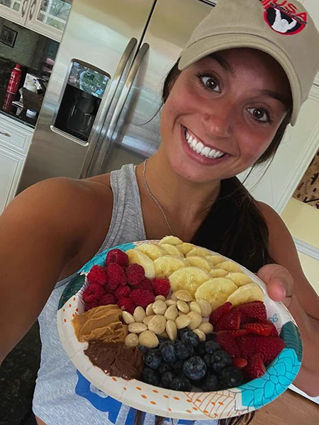 Image of Abby Raymond holding a berry charcuterie board
