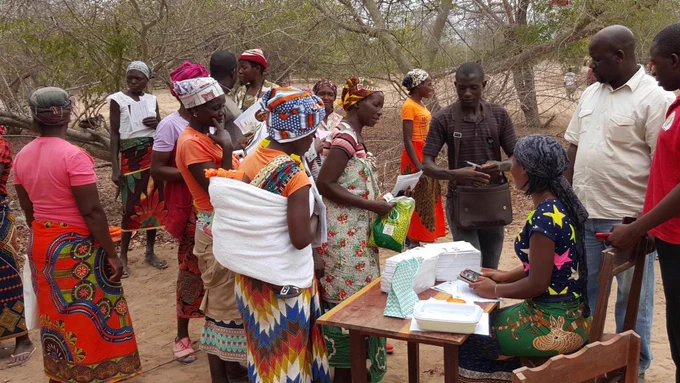 A community holding a meeting and sharing information.
