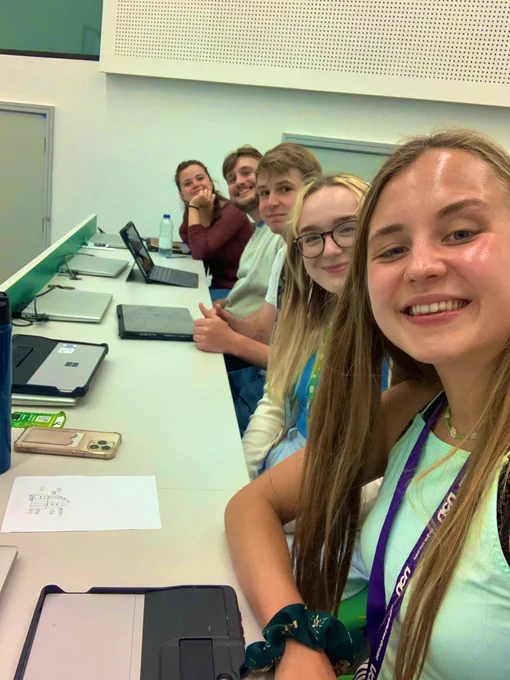 Selfie of Emma and 4 students in meeting room