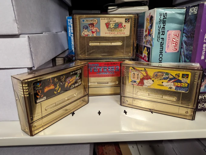 Four gold Super Famicom cartridges used in competition in Japan. Super Bomberman 2, Super Dodgeball, Super Tetris 2   Bombliss, and Super Bomberman 5.