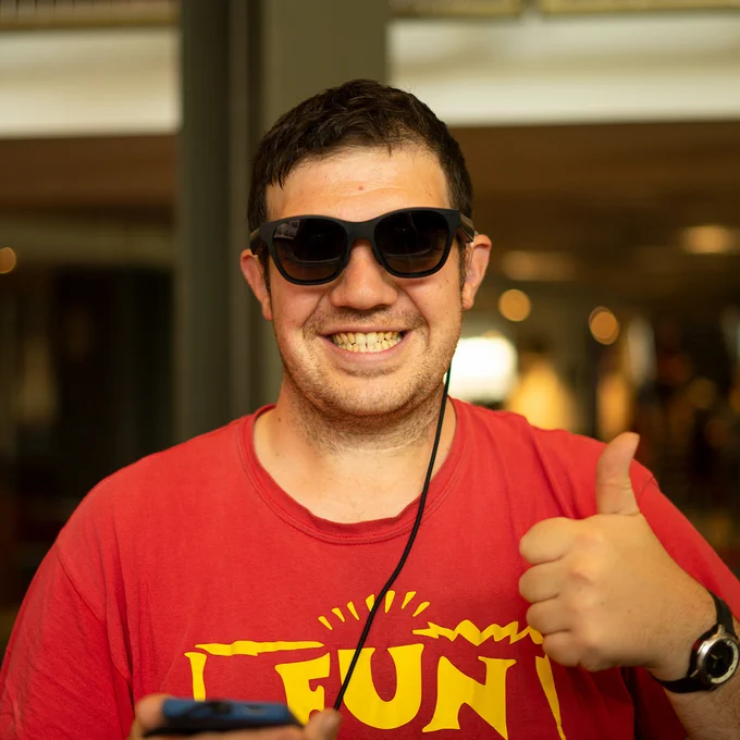 Man trying XRAI Glass at Tech Rootz with his thumb up