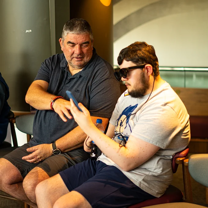 Man helping son use XRAI Glass at Tech Rootz 2023
