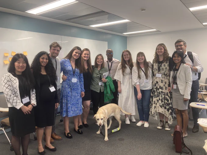 Image shows the Marketplace Access attendees posing with our mascot the wonderful Lassie - the golden Labrador and assistant guide dog.