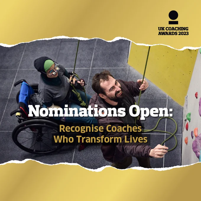 Image: Smiling climbing coach with rope and harness looking up at the wall as young teenager in a wheelchair behind him looks up at the wall. Words overlaid "Nominations Open: Recognise Coaches Who Transform Lives"