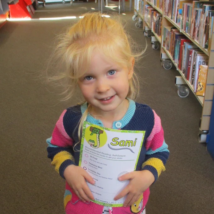 child holding sami snake card