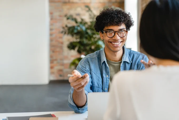Successful young colleagues having negotiation at the working desk in office stock photo