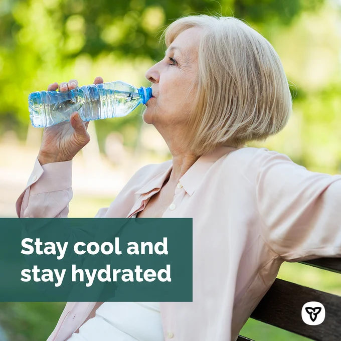 Image text: 
Stay cool and stay hydrated

Image of:
A woman sitting on a park bench drinking water
