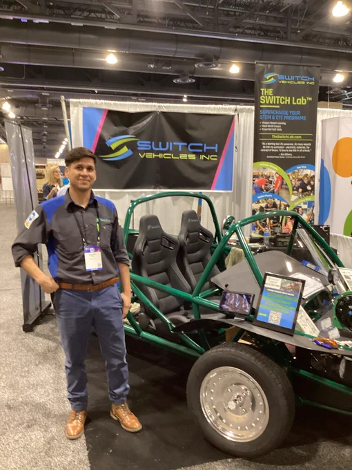 Instructor standing next to electric vehicle 