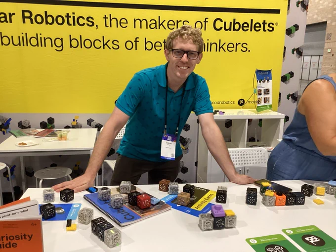 Picture of team member with Cubelets, programmable play blocks.