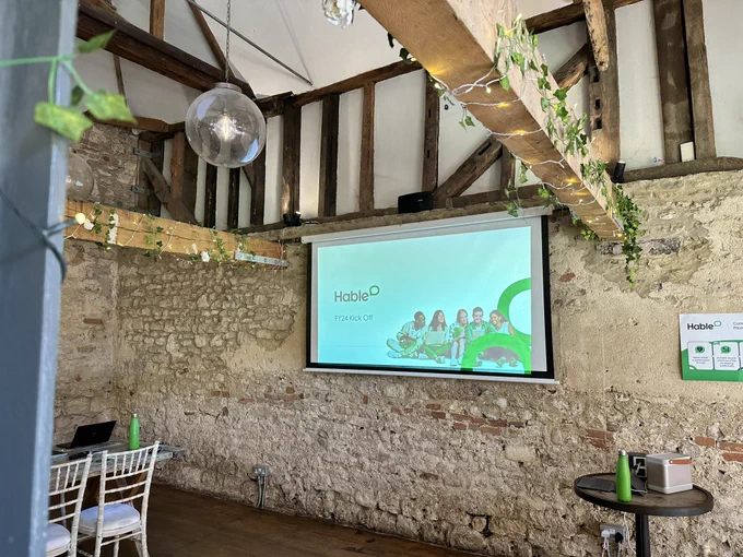 Room with a projector and hable logo on it