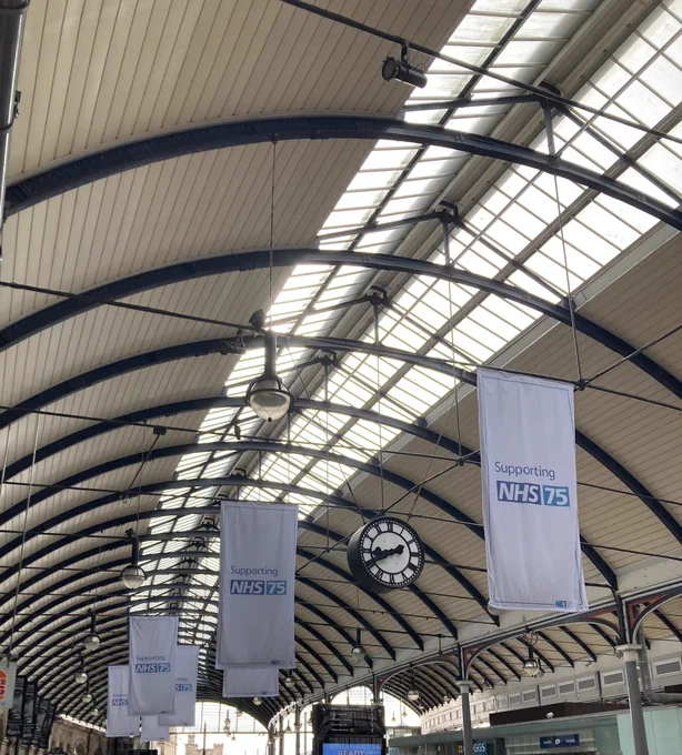 Newcastle Central Station with NHS 75 banners on display.