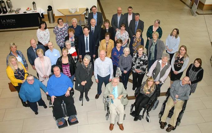 A large group of people pictured from above. They all look at the camera. This is members of the board, staff and stakeholder groups of ILF Scotland and Northern Ireland.