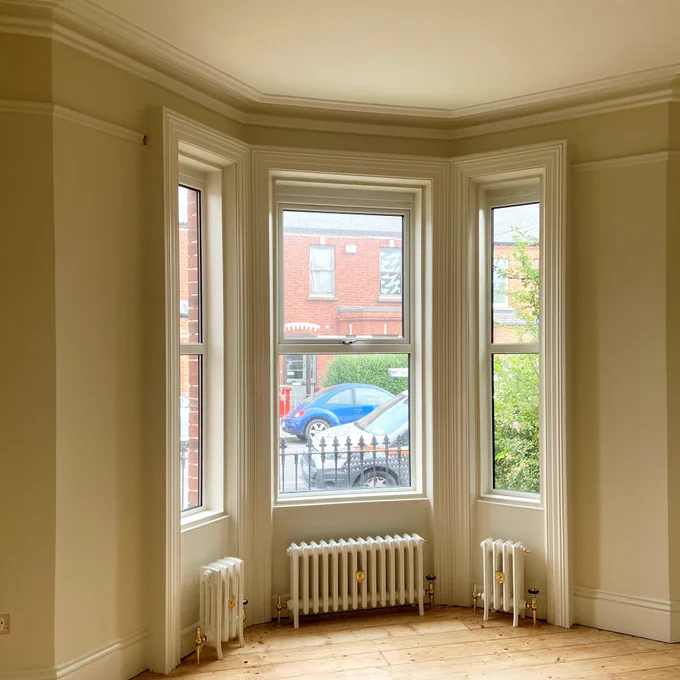 A photo of a beautiful period bay window from inside the room facing out to the street that was painted in Drumcondra by Impressions Dublin Painters and Decorators using “Artic Blonde” by Colourtrend