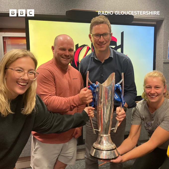 Enya and Millie with Sean and Tom, all holding the trophy in the studio