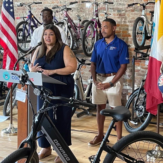 A photo of Council President Shannon Hardin and Councilmember Lourdes Barroso de Padilla announcing an e-bike incentive pilot program at a bike shop.
