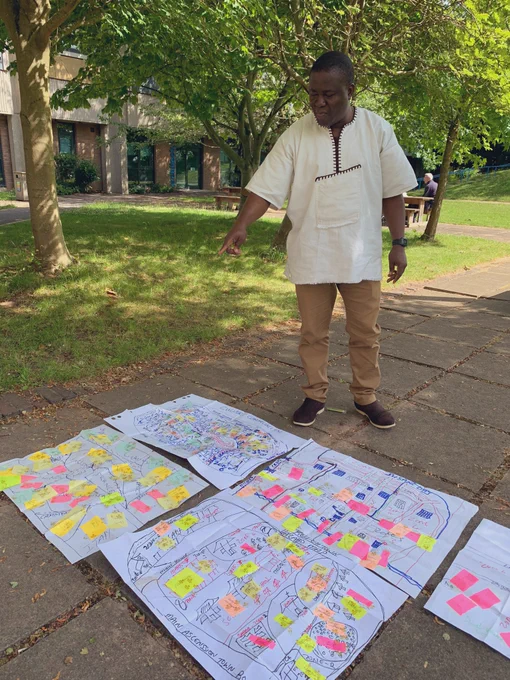 Edwin lays out his community maps on the ground