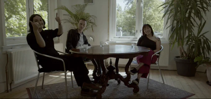 Miriam Matthiessen, Jacob Bolton and Charmaine Chua sat at a fancy wooden table in a room with a bunch of plants, recorded in Ruisgoord, Amsterdam