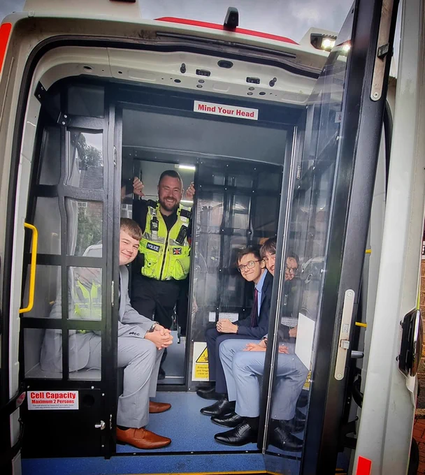 William and his friends Fin and Charlie in the back of a police van after being 'arrested' 