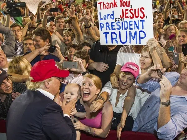 Donald Trump in 2016 greets a screaming horde of ecstatic white christian nationalists