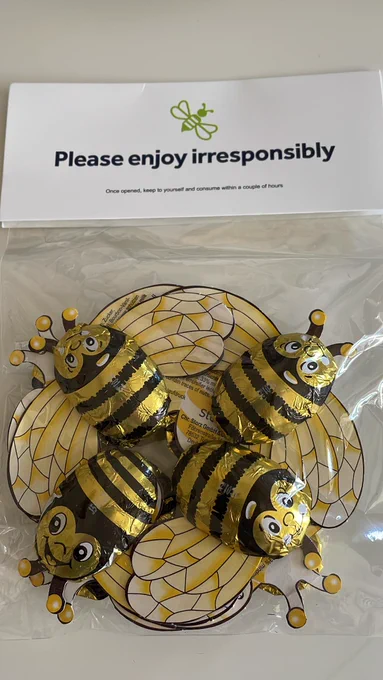 Chocolates in foil wrapping printed so they look like friendly bees, complete with paper wings