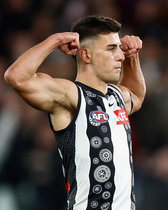 Nick Daicos celebrates a goal at Marvel Stadium.