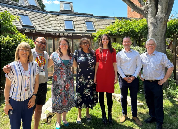 Kiren Collison photographed outside with six members of the Bromley-by-Bow Health Centre Social Prescribing Team. 