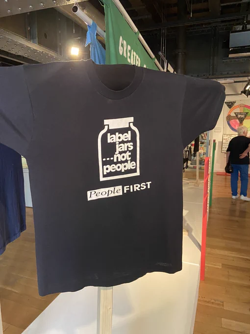 Black t-shirt with the slogan ‘label jars… not people’ from people first