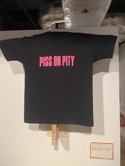 Black t-shirt with ‘Piss on Pity’ slogan