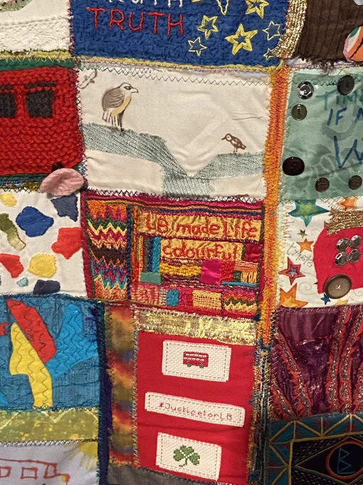 Handful of patches from the quilt. Central patch is colourful and states ‘LB made life colourful’