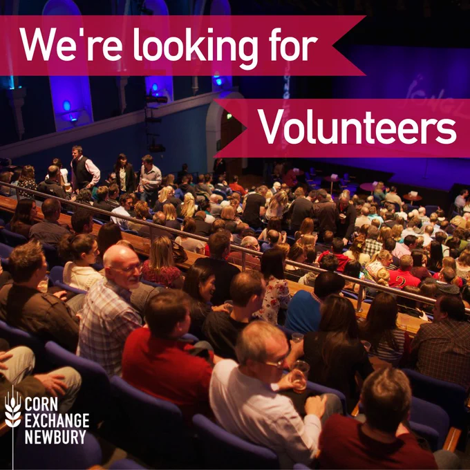 We're looking for Volunteers. Image displays the corn exchange auditorium full with people