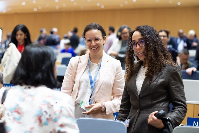 Three female delegates talking to each other at the opening of the Assemblies of the Member States of WIPO.