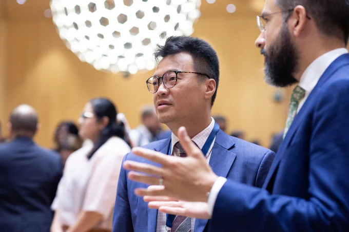 Two male delegates engaged in a discussion at the opening of the Assemblies of the Member States of WIPO.