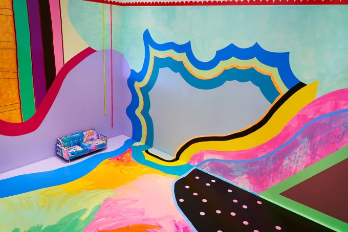 a room with colorful walls and floor paint, part fo an exhibition by artist Sarah Cain