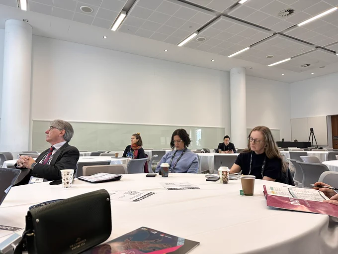 People sitting at tables in a workshop