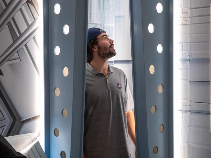 Colby Barlow looks around the room while trying to solve a puzzle at Enigma Escapes