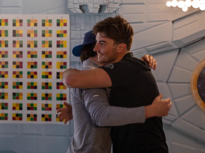 Logan Neaton and Jordan Tourigny hug after successfully solving a puzzle at Enigma Escapes