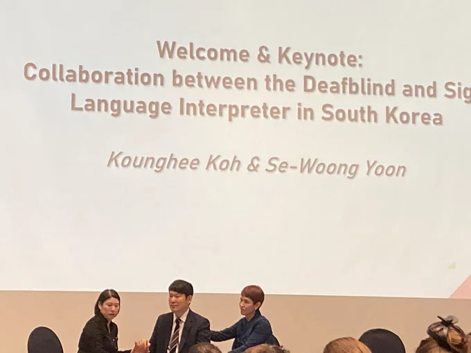Se-Woong Yoon and two tactile deafblind interpreters