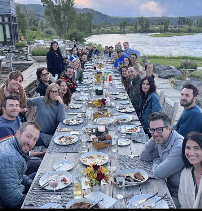 photo shows 28 white men and women at a table together