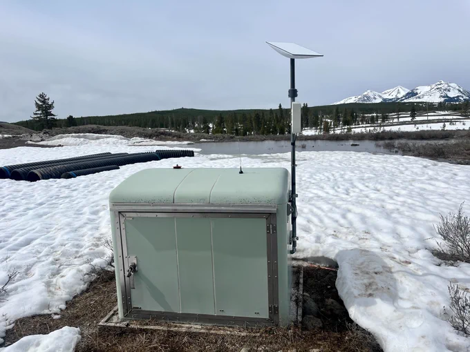 Borehole station B945, near Panther Meadow between Mammoth Hot Springs and Norris Geyser Basin in Yellowstone National Park.  The station was fitted with a new Starlink antenna—the flat white square on top of the pole—in May 2023. Photo by Brendan Hodge, EarthScope Consortium, May 10, 2023.
