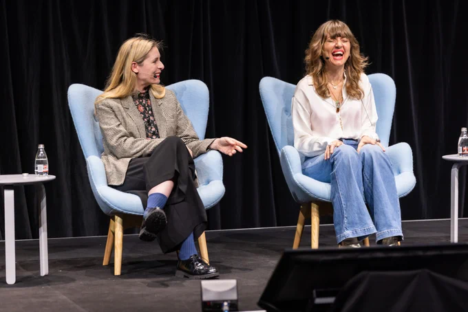 Holly Ringland laughing on stage at Sydney Writers' Festival 2023, while Eleanor Catton gestures towards her.
