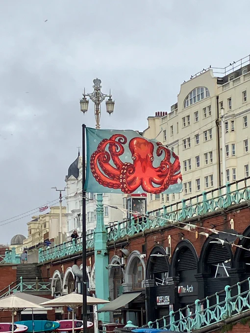 In the Center of the picture is a flag with a Kraken. The flag is moving in the wind.