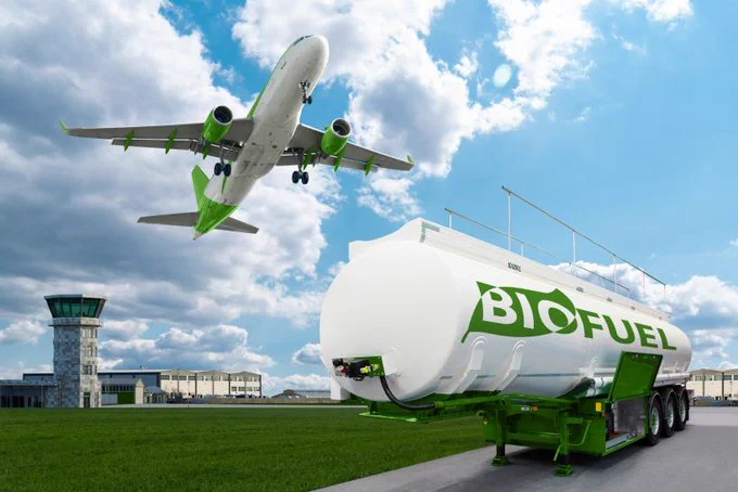 Commercial plane takes off from airport with a biofuel tank in the foreground