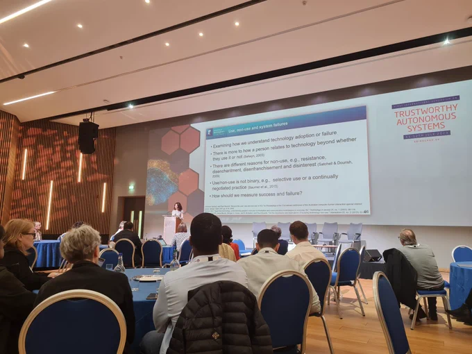 Andriana presenting to a crowd at the Trustworthy Autonomous Systems Symposium. 