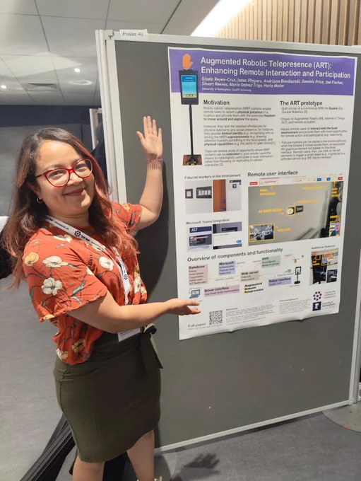 Gisela gesturing at the research poster 