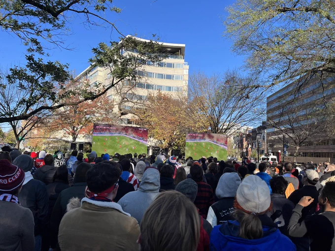 Picture of the crowd and TV screens showing the Wales-USA World Cup 2022 match at the Soccer in the Circle event.