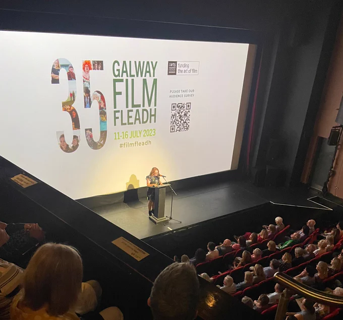 Maeve McGrath standing at a podium on stage at the Town Hall Theatre Galway 