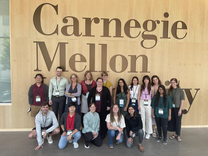 Group photo of participants of the DIS doctoral consortium in front of a CMU sign.