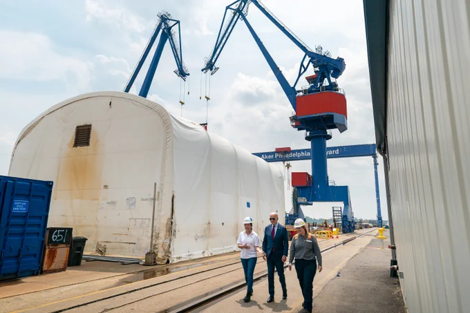 President Joe Biden tours a shipyard with Megan Heileman, Manager, PSI Apprentice Program, left, and Emily Andrewson, apprentice welder, in Philadelphia, Thursday, July 20, 2023.