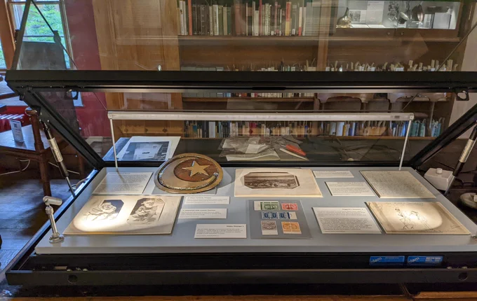 Photograph of open display case of photographs, objects and documents pertaining to T.E. Lawrence