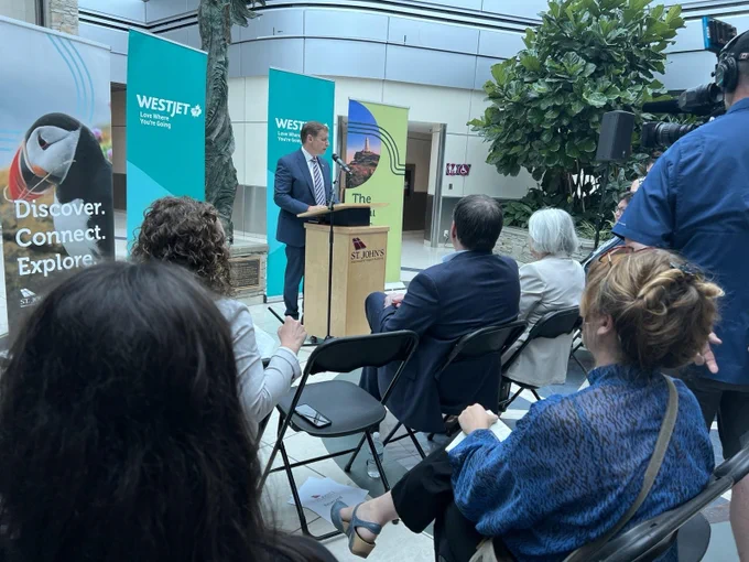 Premier Furey speaking at a podium at the St. John's Airport. 